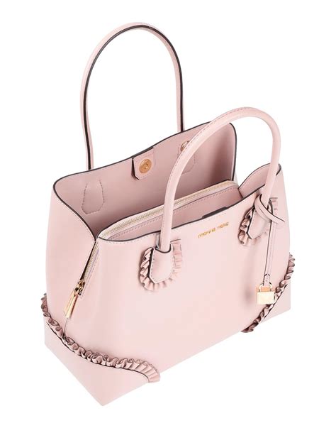 michael kors white and light pink hand bags|Michael Kors pink suitcase.